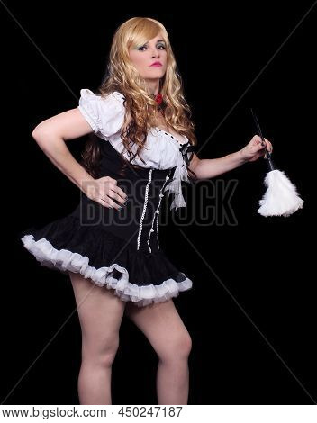 Blonde Woman In French Maid Costume With Feather Duster On Black