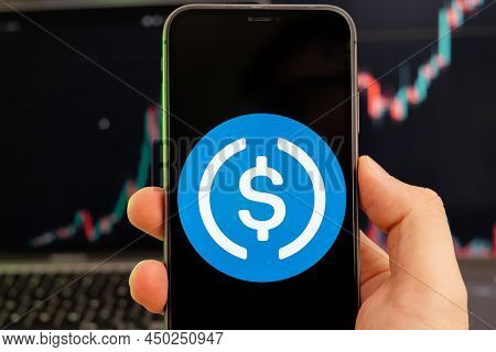 Usd Coin Cryptocurrency Logo On The Screen Of A Smartphone In Mans Hand With A Growing Trend On The 