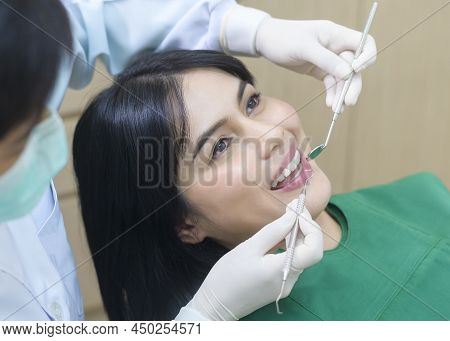 Young woman having teeth examined by dentist in dental clinic, teeth check-up and Healthy teeth conc