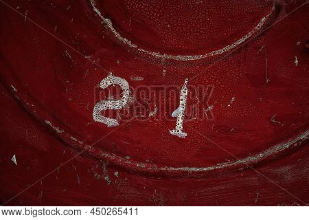 Number Twenty One Printed In White On The Dark Red Textured Background