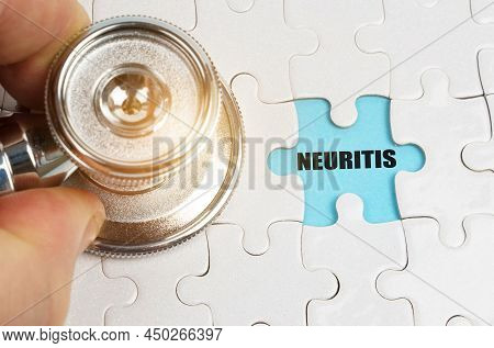 Medical Concept. On Puzzles A Hand With A Stethoscope, On A Blue Background The Inscription - Neurit
