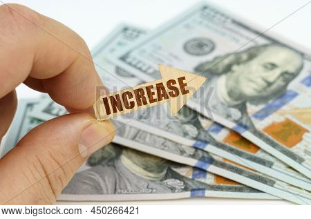 Business And Finance Concept. In The Hands Of A Man Is An Arrow With The Inscription - Increase, In 