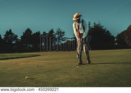 View Of A Fancy Mature African Guy In An Elegant Retro Outfit With A Straw Hat And A Tie Hitting The