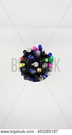 Different Varieties Of Gel, Ball And Colorful Pens In A Black Pen Holder Isolated In A White Backgro