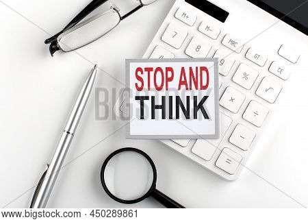 Stop And Think Text On Sticker With Calculator, Glasses And Magnifier