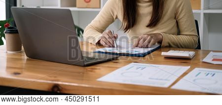 Finance Business People Or Accountants Point To The Graph And Use A Calculator To Calculate Company 