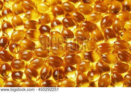Golden Vitamin D3 Capsules Close-up In Full Screen
