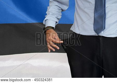 Hand Of Man In Suit Turning Pocket Of His Trousers Inside Out And Showing It Empty On The Background