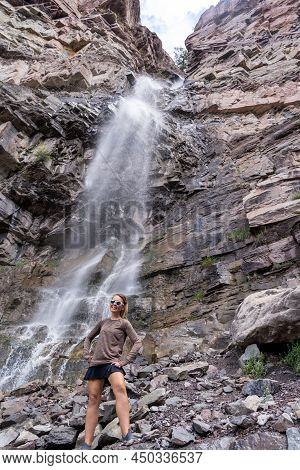 Woman Hiker Poses At Cascade Falls Waterfall In Ouray Colorado