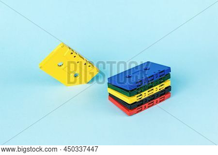A Creative Set Of Multi-colored Tape Cassettes On A Blue Background. Vintage Style In Sound Recordin