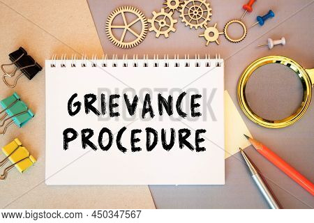 Text Grievance Procedure On Notepad With Office Tools, Pen On Financial Report . Business And Financ