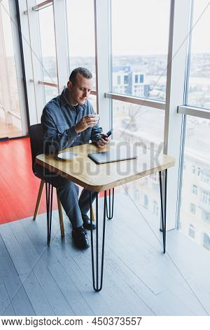 Happy Smiling Male Manager Sitting In Cafe Using Mobile Phone Gadget, Ordering Delivery Service Via