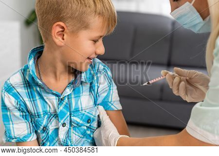 Female Doctor Making Injection To Little Boy