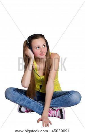 girl in headphones listens to music and laughs