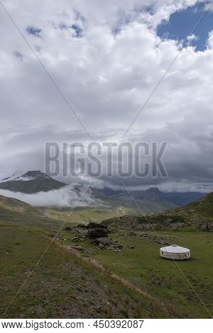 A Large And Lonely Circular Tent In The Middle Of A Mountain Landscape On A Cloudy Summer Day, Pyren