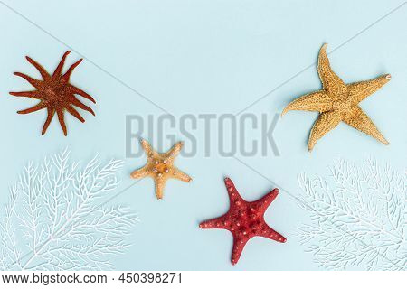 Summer Flat Lay With Red And Yellow Sea Star And White Coral On Blue Background. Summer Time Rest Co