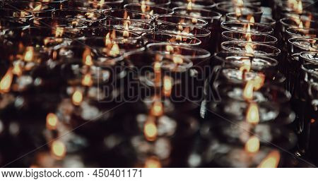 Detail Of Many Red Votive Candles Light Inside Chinese Temple. Rows Of Votive Candles In Glass With 