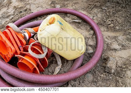 Construction Hose, Water Canister And Orange Cones Are On The Ground Again