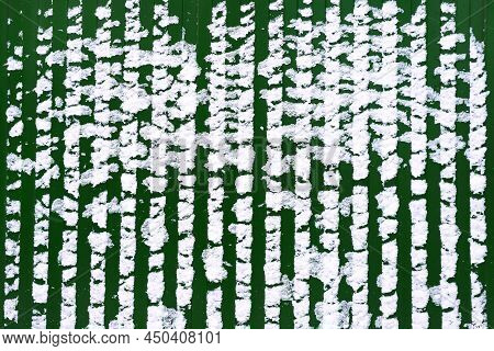 Green Fence Stands At A Construction Site Swept Up By The Snow Cold