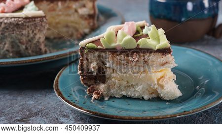 Piece Of Kyiv Cake With Chocolate Cream And Decorated Top On Blue Plate