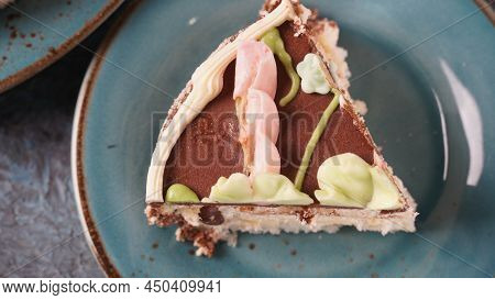 Piece Of Kyiv Cake With Chocolate Cream And Decorated Top On Blue Plate