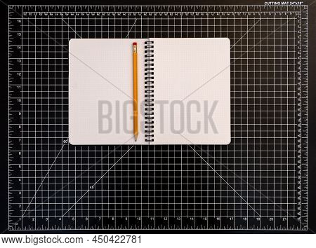 Notepad With Pencil On Black Cutting Mat, Copy Space