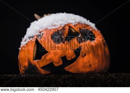 Jack-o-lantern Rotting In The Snow After Halloween