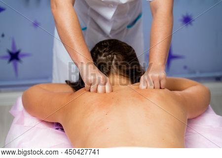 Facial Massage. A Woman Is Given A Massage In A Beauty Salon. Close-up.