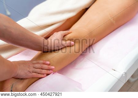Facial Massage. A Woman Is Given A Massage In A Beauty Salon. Close-up.