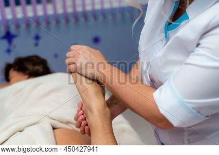Facial Massage. A Woman Is Given A Massage In A Beauty Salon. Close-up.