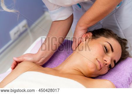 Facial Massage. A Woman Is Given A Massage In A Beauty Salon. Close-up.