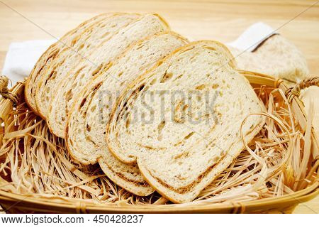 Rye & Pumpernickel Swirled Loaf Of Bread In A Breadbasket