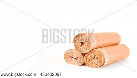 Orange Rolls Of Garbage Trash Bin Bags Isolated On White Background With Copy Space