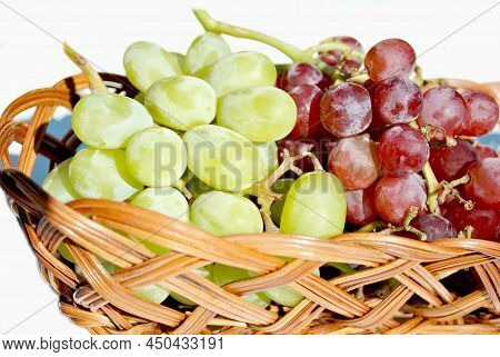 Basket Of Red And Green Grapes On A Sunny Spring Day