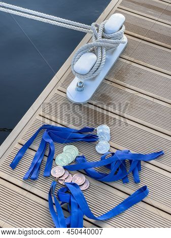 The Sea Rope On The Knecht In New Port, A Lot Of Medals Of The Winners Of The Yacht Regatta Lie On T