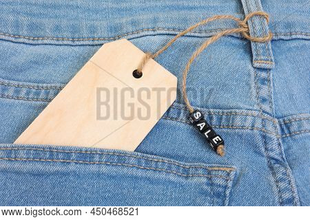 Blank Wooden Label Tag And Sale Sign On Jeans