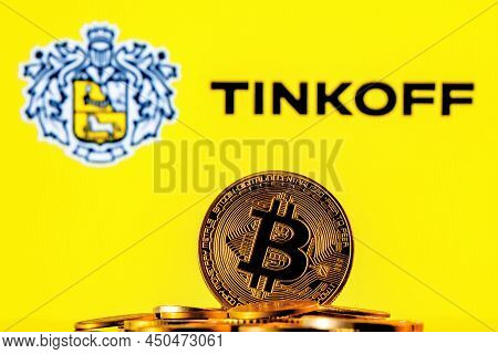 Kazan, Russia - Mar 06, 2022: Golden Bitcoin In Pile Of Coins On Background Of Tinkoff Bank Logo