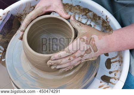 Close Up Hands Working On Pottery Wheel And Making A Clay Pot, Selective Focus