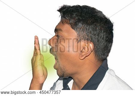Bad Breath. Halitosis Concept. Young Indian Man Checking His Breath With His Hand.