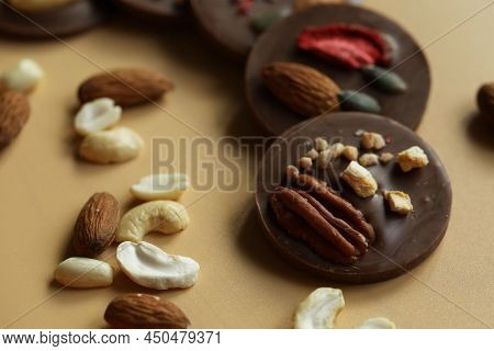 Black Chocolate Mendiants With Nuts On The Table