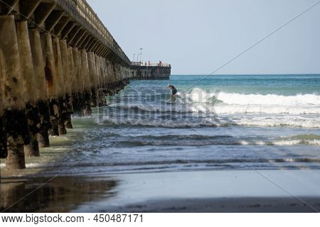 Tolaga Bay New Zealand - February 5 2022; Surfer Riding Waves By Tolaga Bay Wharf