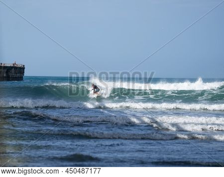 Tolaga Bay New Zealand - February 5 2022; Surfer Riding Waves By Tolaga Bay Wharf