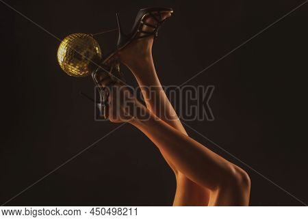 Party Time. Disco Legs. Celebrate Concept. Heels With Gold Ball.