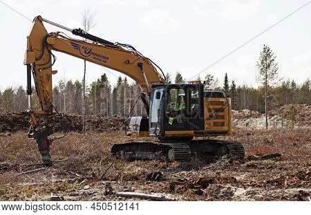 Umea, Norrland Sweden - April 30, 2020: Tree Felling Machine On Clear-cutting