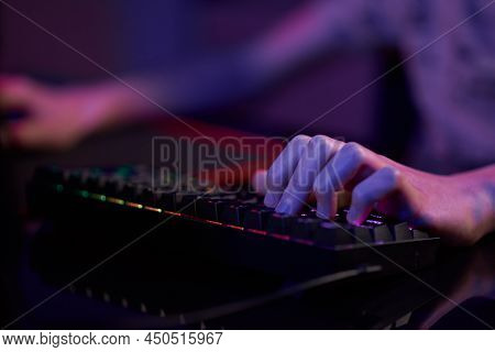 Professional Gamer Play Computer Video Game In Dark Room, Use Neon Colored Rgb Mechanical Keyboard, 