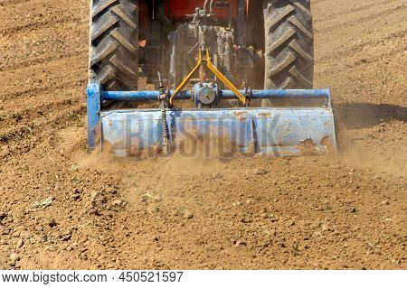 Field Preparation By Rotary Tiller Tractor In Farm