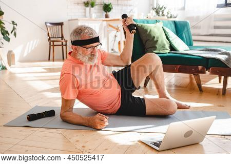 Elderly Aged Male Exercising With Dumbbells During Online Training. Old Person Man Pensioner Healthy