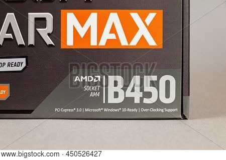 Msi B450 Mortal Max Motherboard Against A Gray Background. Black Box With The New Computer Hardware.