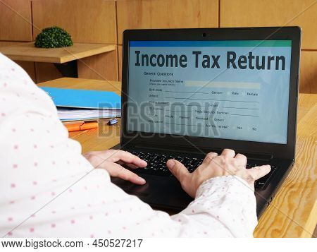 Income Tax Return Is Shown On A Business Photo Using The Text