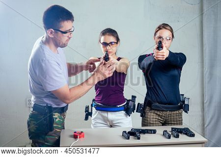 A Woman Target Practicing With A Handgun For Self Defense